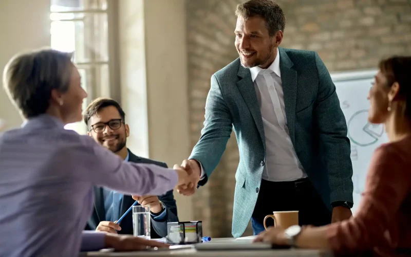 business-coworkers-shaking-hands-meeting-office-focus-is-businessman-scaled-1.webp