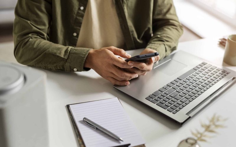 high-angle-man-holding-smartphone