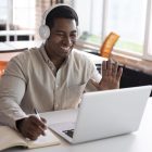 medium-shot-man-waving-laptop